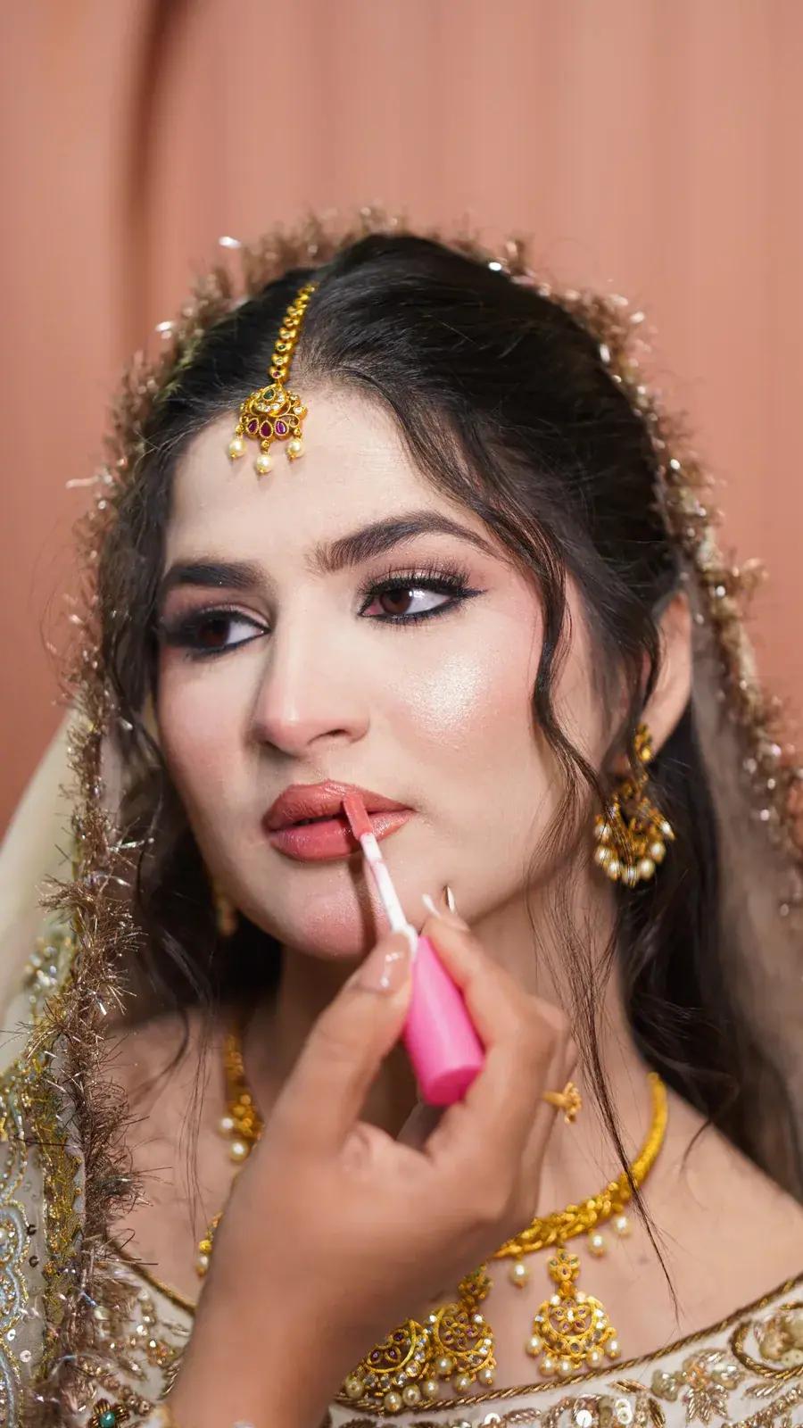 Bridal makeup finishing touch with lip gloss at House of Salons Bahria Town (Ladies), Bahria Town Phase 7, Rawalpindi