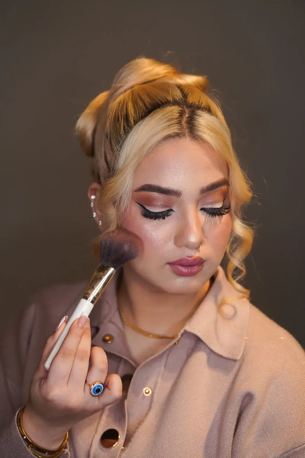Makeup artist at work, adding blush and contour at House of Salons F-10 (Unisex), F-10 Markaz, Islamabad
