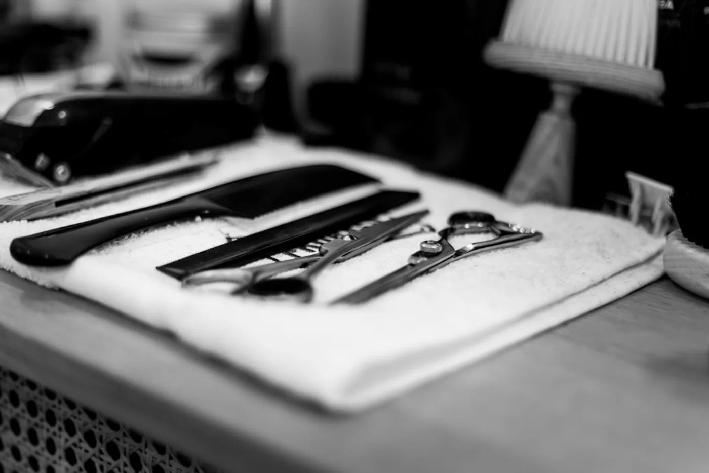 Barber applying hot towel treatment during a beard grooming session