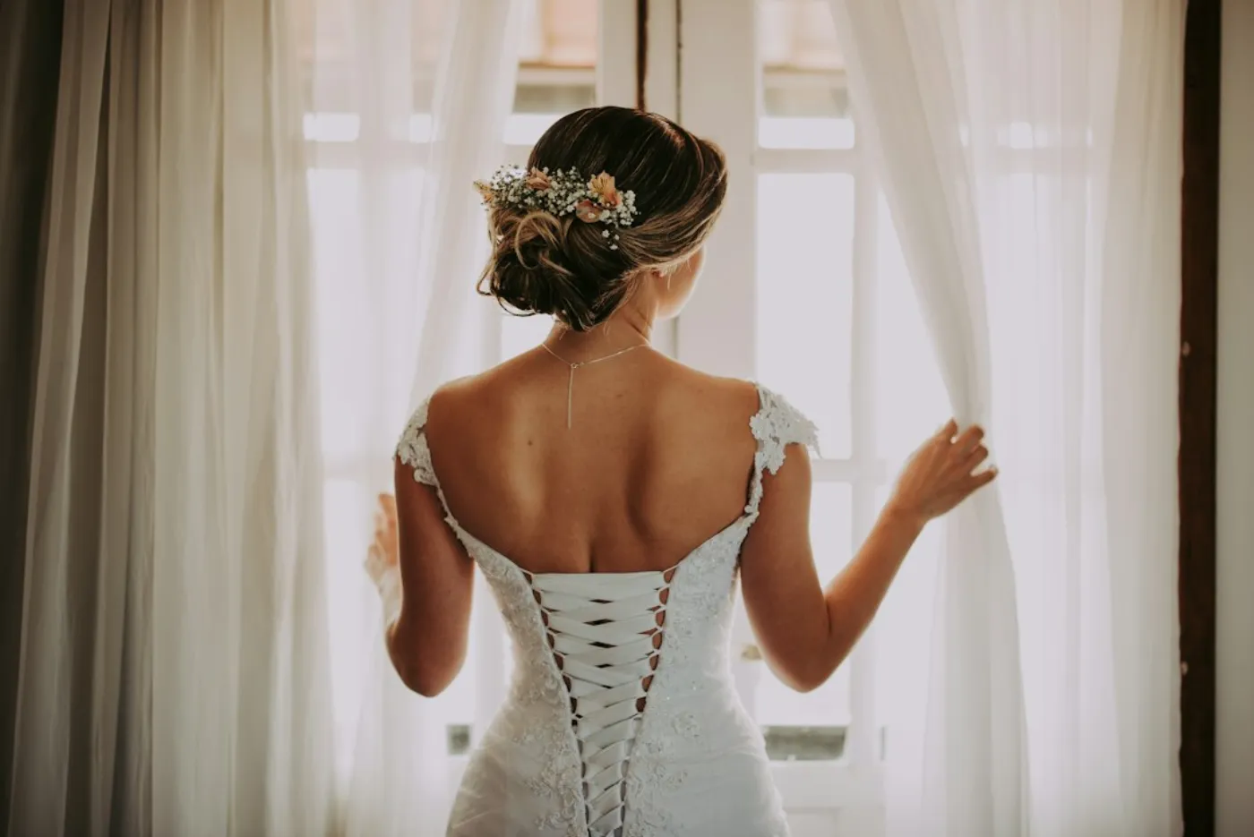 A bride having her wedding hairstyle perfected in a luxury salon setting