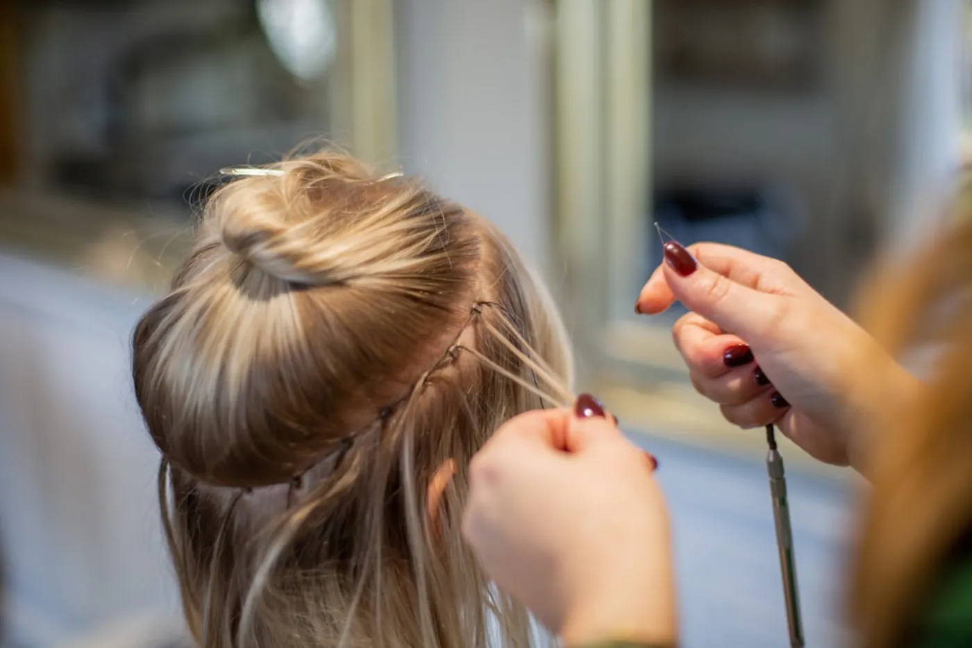 Stylist consulting client on haircut