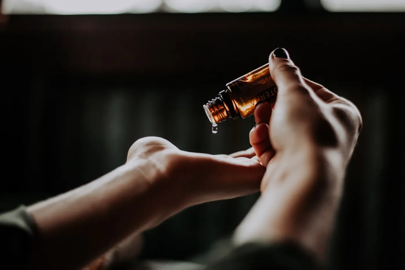 Stylist applying nourishing serum to hair in salon