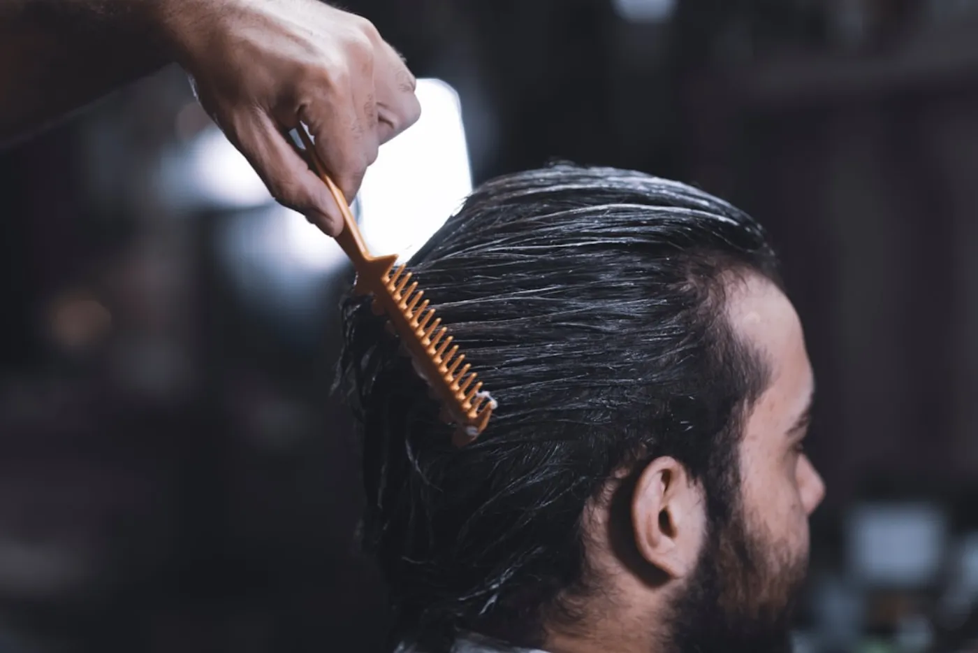 Various men's hair styling products laid out on a salon counter.