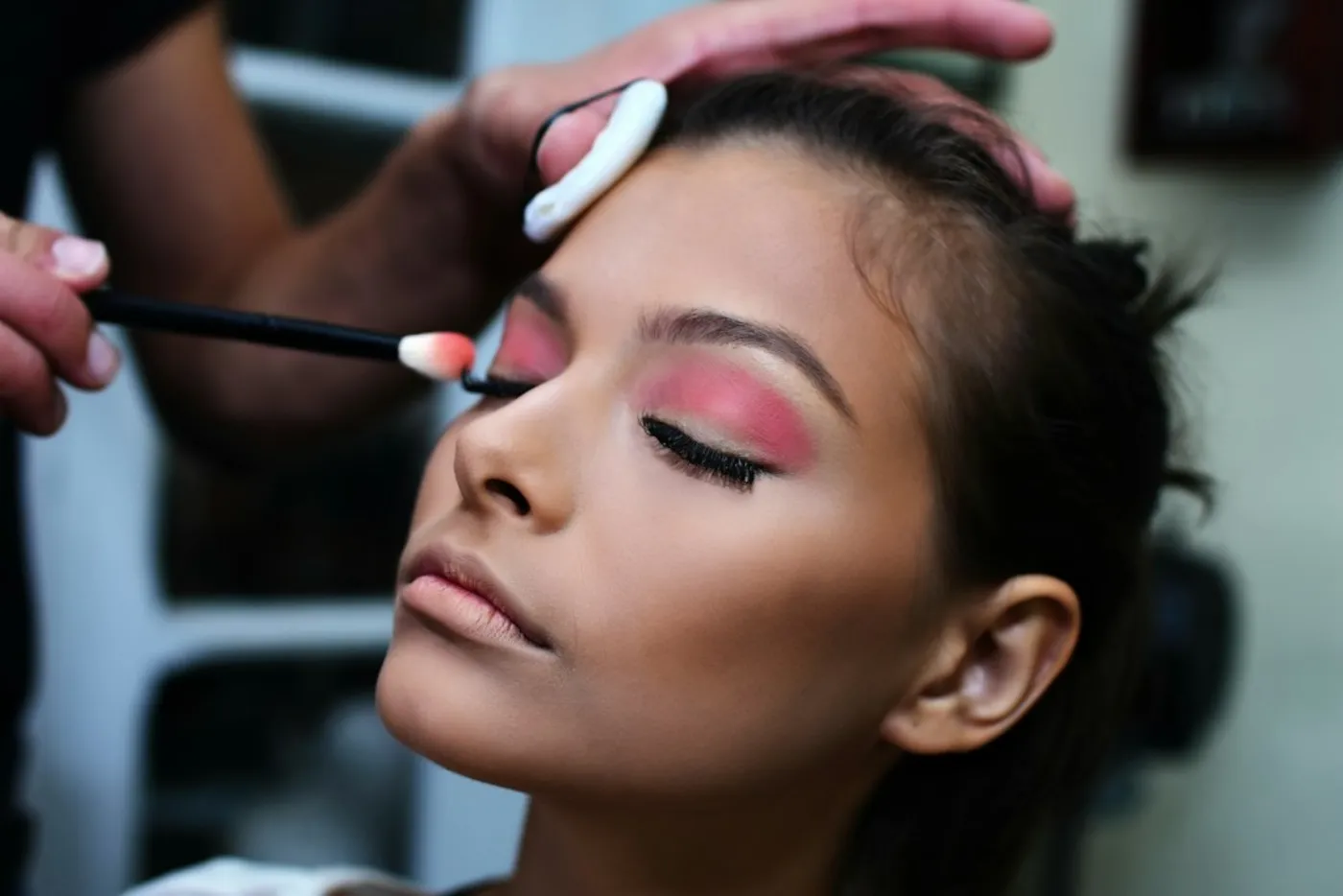 Nikah makeup artist applying soft dewy eyeshadow in an Islamabad salon
