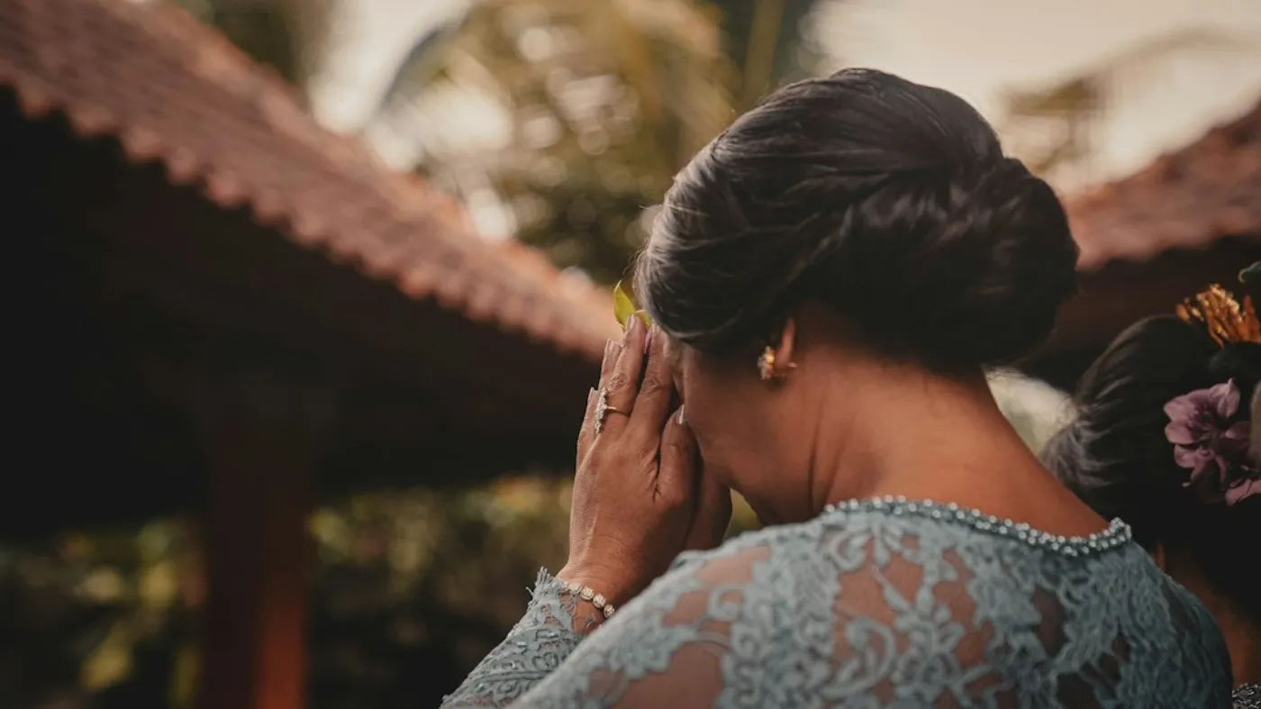 Romantic low bun hair styling with delicate floral accents for an engagement