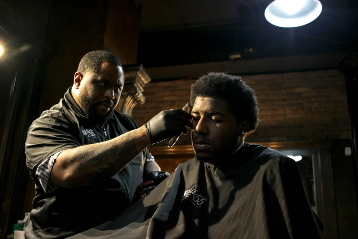 Groom receiving precision beard trimming and hair styling in Islamabad barber studio