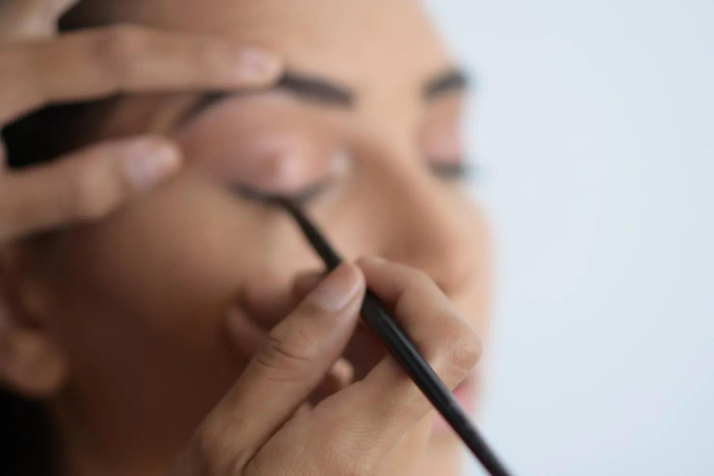 Professional makeup artist carefully applying makeup to a client