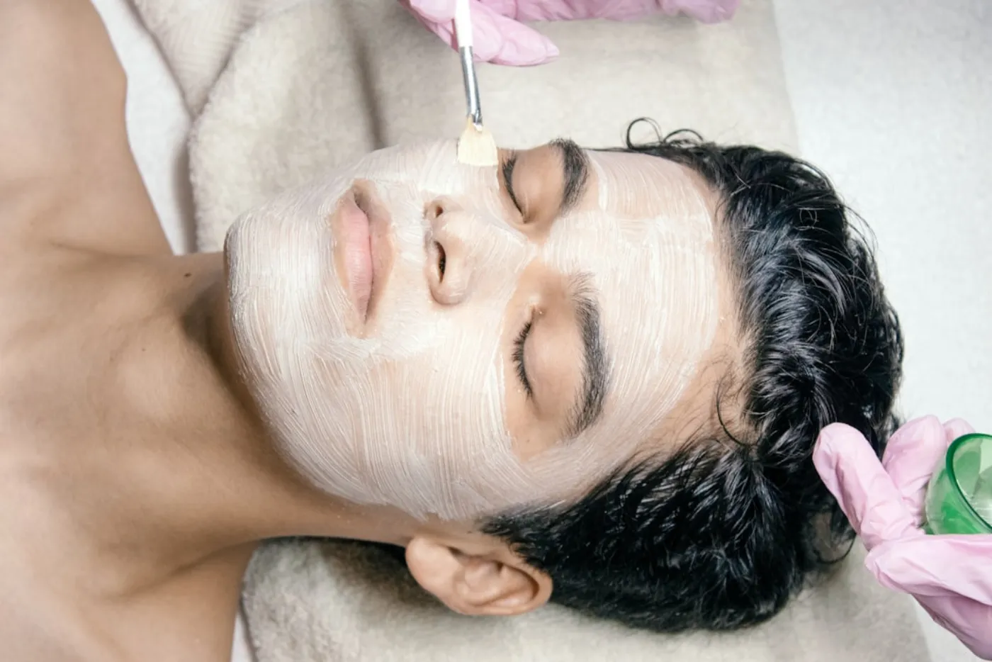 Man enjoying a refreshing facial treatment at a professional salon