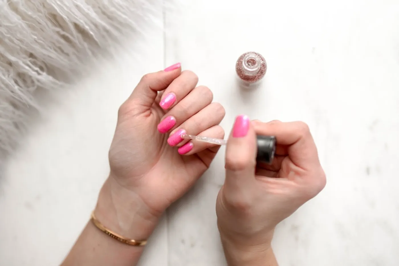 Professional nail technician applying gel polish in a modern salon