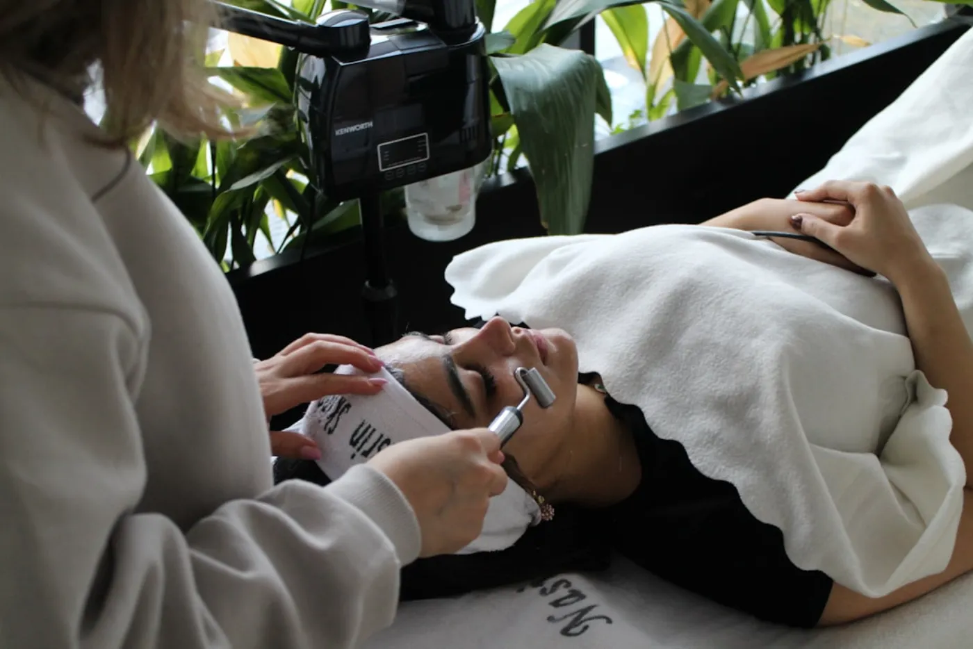 A client enjoying a relaxing and hydrating facial treatment in a clean, professional salon environment, demonstrating premium skincare.