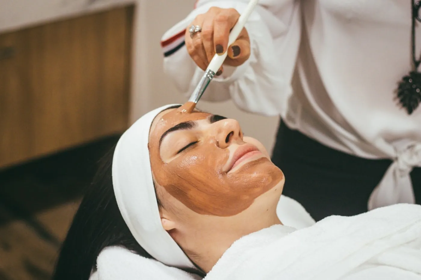 Woman receiving a refreshing hydrating facial at a salon
