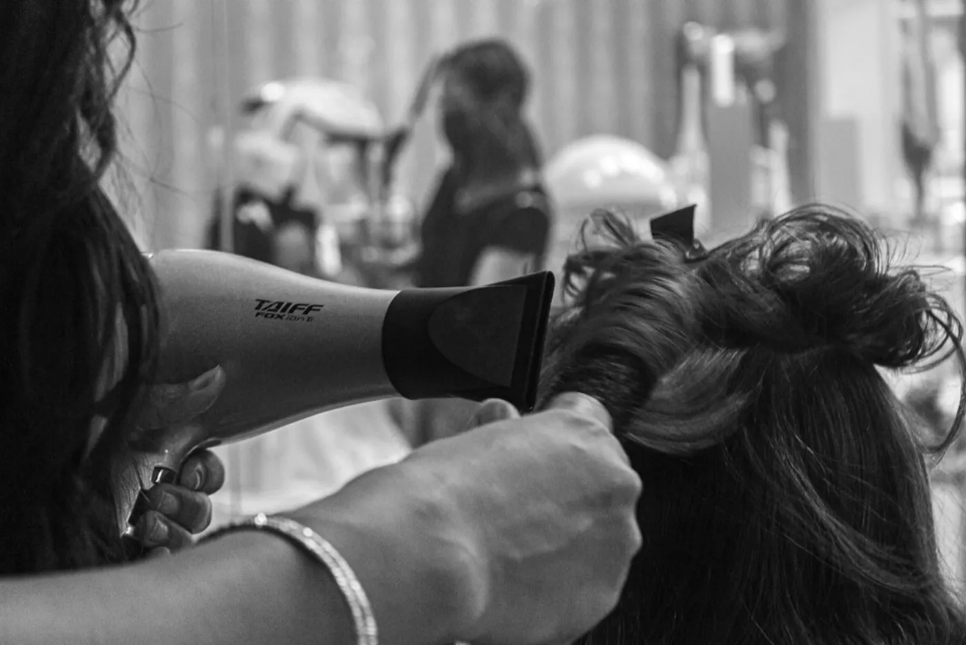 Stylist preparing hair nourishing treatment in modern salon