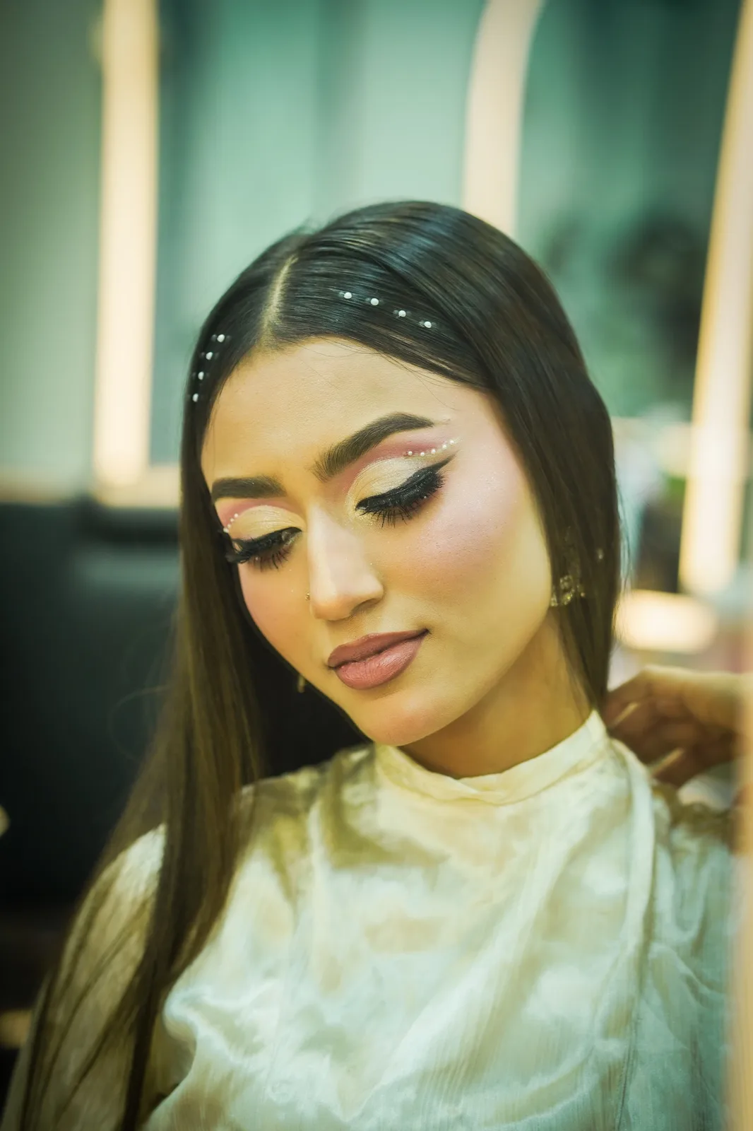 Party makeup with sleek straight hair and pearl detailing, done at House of Salons F-10