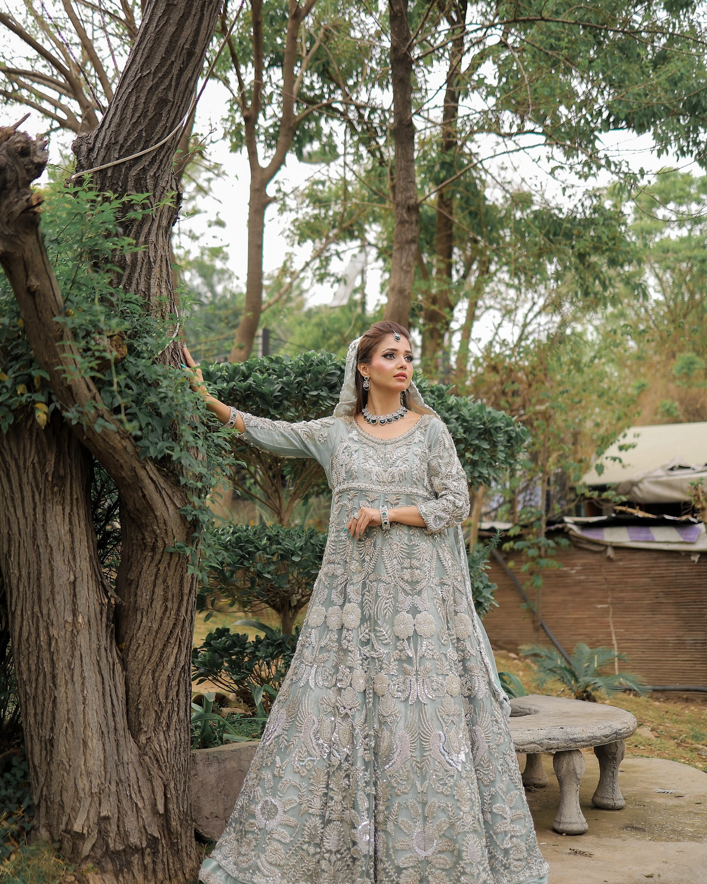 Bridal makeup and hairstyling in an outdoor garden setting by House of Salons