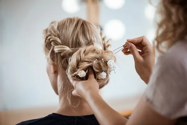 female hairdresser making hairstyle